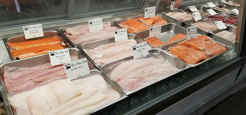 different variety of fresh fish in refrigerated case at Mr. Bill's